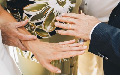 Old lady in green dress holds bride's hand tender